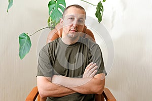 A young man suffering from depression sits in a psychologist's office. concept of mental health, psychotherapy