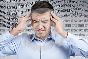 Young man suffering from depression and words STRESS on background