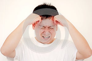 Young man is suffering from a headache,picture showing how much his head hurts,experiencing pain.