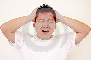 Young man is suffering from a headache,picture showing how much his head hurts,experiencing pain.