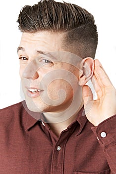 Young Man Suffering With Hearing Difficulties