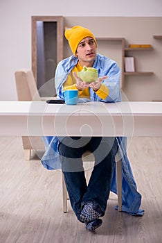 Young man suffering at home in expensive medicine concept