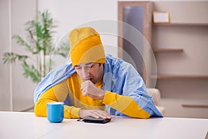 Young man suffering at home in expensive medicine concept