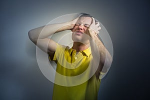 Young man suffering from an intense headache/migraine/anxiety attack