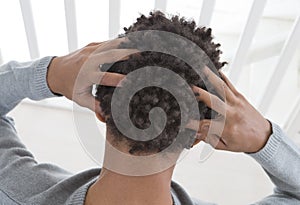 Young man suffering from itchy scalp