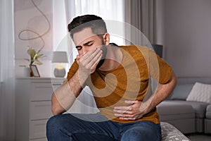Young man suffering from nausea. Food poisoning
