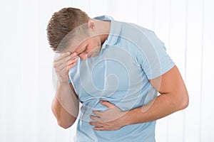 Young Man Suffering From Stomach Ache