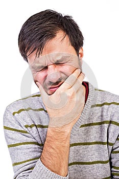 Young man suffering from a terrible tooth ache