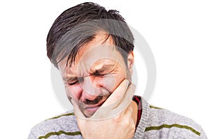 Young man suffering from a terrible tooth ache