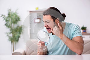 Young man suffering from toothache