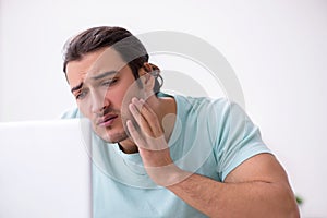 Young man suffering from toothache