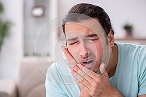 Young man suffering from toothache