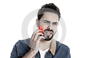 Young man suffering from toothache on background