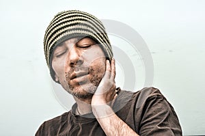 Young man suffering from toothache pain