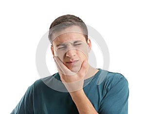 Young man suffering from toothache on white background