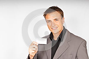 Young man in suit with business card