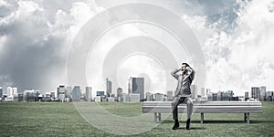 Young man in suit in park dont want to hear anything