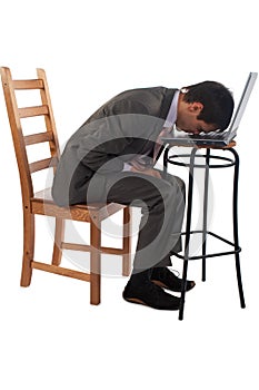 Young man in suit put head on laptop