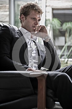 Young man in suit thinking
