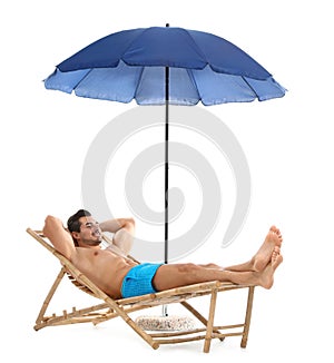 Young man on sun lounger under umbrella against white background. Beach