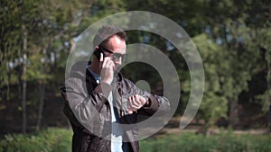 Young man in sunglasses talkning by phone