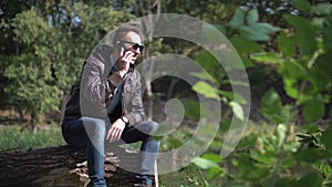 Young man in sunglasses talkning by phone