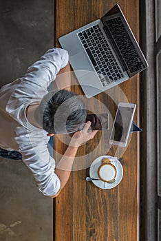 Young man surfing Internet on smartphone