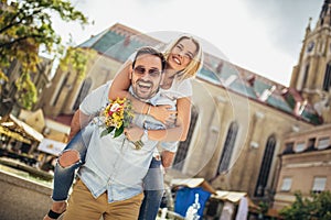 Young man surprising woman with flowers