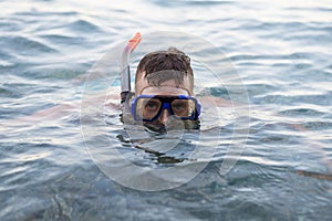 Young man swiming in a diving mask