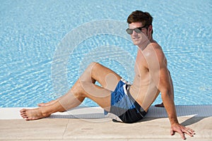 Young man by swimming-pool