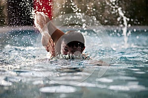 Young Man Swimming In Pool