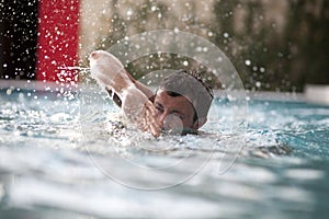 Young Man Swimming In Pool