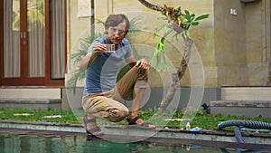 Young man swimming pool serviceman checking chlorine, PH and other chemical levels