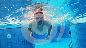 Young man swimming underwater