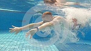 Young man swimming underwater