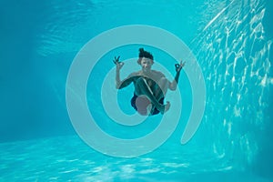 Young man swimming underwater