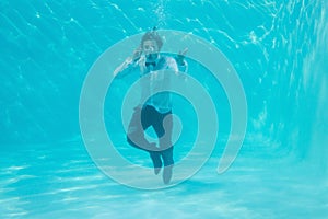 Young man swimming underwater