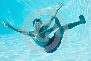 Young man swimming underwater