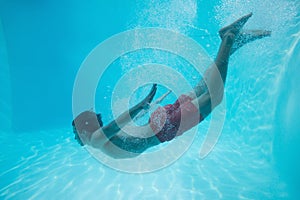 Young man swimming underwater