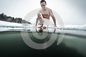 Young man swims in the ice hole