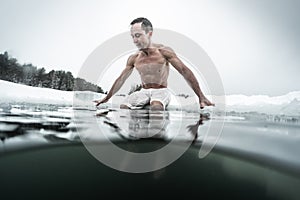 Young man swims in the ice hole