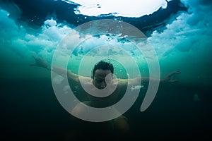 Young man swims in the ice hole
