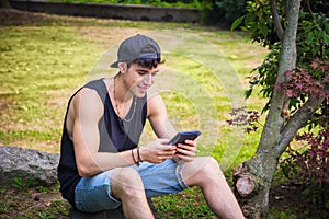 Young Man with Tablet or Ebook Reader Relaxing at