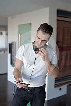 Young man with tablet and headphones at home