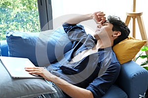 Young man take a nap after overworked at home