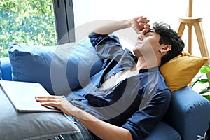 Young man take a nap after overworked at home photo