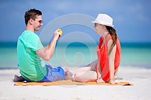 Young man take photo of his girlfriend by the phone on the beach