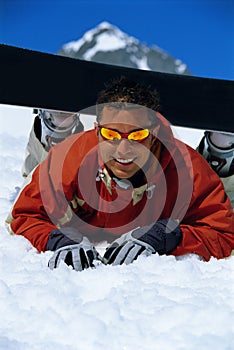 Young man taking a break from snowboarding