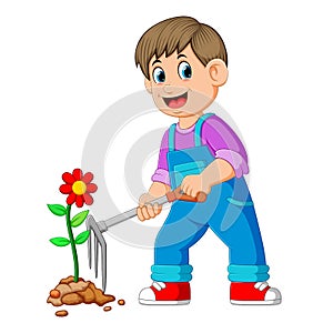 Young man taking care of plants and using the rake