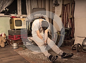 Young Man Taking a Nap at Messy Abandoned Room